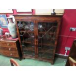 A George III flame mahogany astragal glazed two door bookcase the height adjustable shelves over