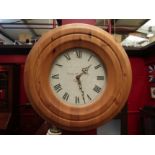 A "Bridewell Clocks" wall clock with pine surround, 48cm diameter