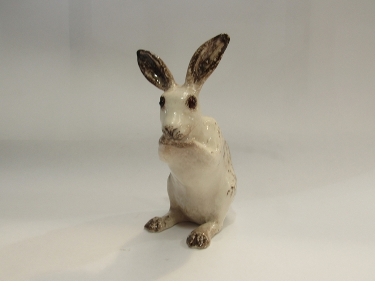 A Winstanley figure of a seated rabbit, crazed, 18cm high