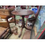 A mahogany tilt-top table with bird cage mechanism on bun feet