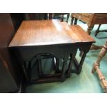 An oak nest of 17th Century style three graduating occasional tables on turned legs joined by