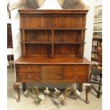 An 18th Century Continental oak dresser, bobbin-turned supports to plate rack back, four drawers and