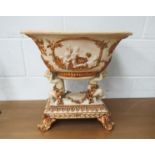 An ornate plastic centrepiece with cherubs supporting large bowl, 42cm tall x 40cm wide
