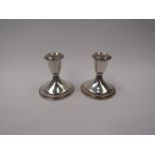 A pair of weighted candlesticks, marked sterling, 8.5cm high