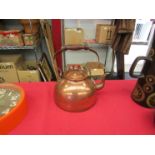 A Copper kettle with wooden handle