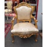 A reproduction French gilt open armchair, upholstered seat and back rest