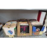 Three boxes of 7" singles including T-Rex, Tom Robinson Bond, Seal, Sex Pistols, Bob Marley and