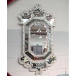 An ornate reproduction venetian glass wall mirror. 125 x 70cm