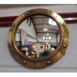 A convex brass porthole mirror, 30cm diameter
