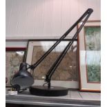 A black anglepoise style lamp