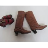 A pair of tan leather knee length boots with a stacked heel and a pair of 1970 terracotta leather