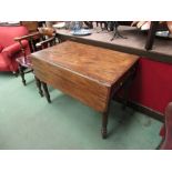 A 19th Century mahogany drop-leaf table with single drawer and faux drawer on turned legs
