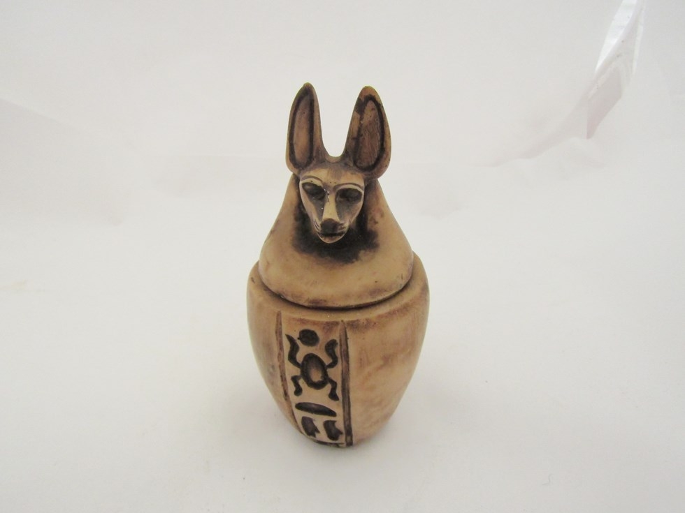 An alabaster Egyptian lidded jar with ancient pharaonic deity Anubis lid