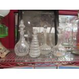 Three glass decanters and a glass condiment bottle, some a/f