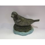 A cast iron seal door stop. 16.5cm tall