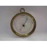 A circular brass barometer
