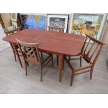 A G-Plan teak extending dining table with four teak chairs, G-Plan labels circa 1965, fully