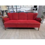 A 1940's Danish three seater sofa, stained hardwood arms and original red embossed fabric