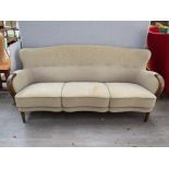 A 1940's Danish three seater sofa with original cream embossed fabric upholstery, dark stained