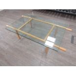 An Italian Cassina coffee table, thick plate glass top on Beech base. 139cm x 80cm x 37.5cm high