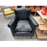 A 1940's Danish black leather and studded armchair raised on tapering hardwood legs. 74cm x 73cm x