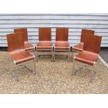 A set of six Italian mid 20th Century walnut veneered bent ply dining chairs on chromed metal frames