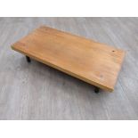 A Habitat Japanese inspired low table with a thick wooden top on black metal legs. 90cm x 45cm x