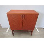 A Danish teak record/media cabinet raised on castors. Fitted interior. 68.5cm x 40cm x 79cm