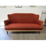 A 1940's Danish three seater sofa, stained Beech arms and original terracotta embossed fabric