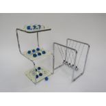 A Newtons cradle executive toy and a 3D multi level checkers stand with glass marbles