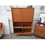 A Danish teak cabinet bookcase - twin sliding door top with open and fitted bookcase below, raised