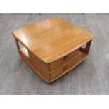 An Ercol 'Pandora's Box' coffee table in light Elm finish. 81.5cm x 80cm x 40cm high