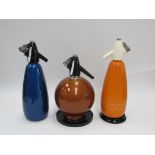 Three c1960's Soda Syphons, one of spherical form. Tallest 32cm
