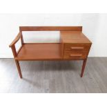 A 1960's Chippy Heath teak telephone table seat. 92cm x 45cm x 63cm high