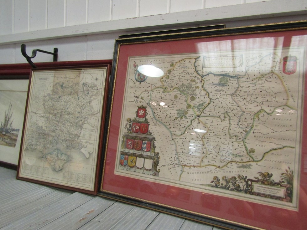 A coloured engraved county map of Leicestershire with coat of arms to lower left corner, framed