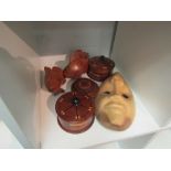 A collection of wooden wares: mask, small pot containing Chinese dolls, fish, etc