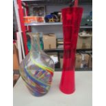 A large studio glass vase together with a tall cranberry glass vase