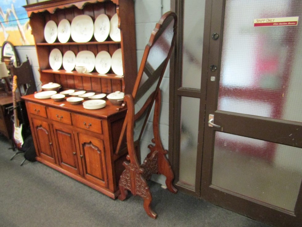 An 18th Century style walnut cheval mirror with shaped top, blind-fret carved base