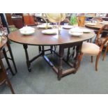 A 19th Century oak gate-leg dining table on turned legs with single frieze drawer