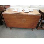 A George III mahogany drop-flap table on square leg supports