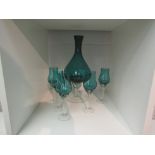 A retro blue glass vase form decanter and five matching glasses