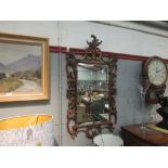 A reproduction French gilt foliate pierced wall mirror with scrolled detail, 105cm x 57cm