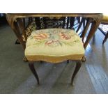A Victorian needlepoint stool over stuff seat, serpentine front on slender cabriole legs