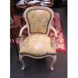 A reproduction Louis XVI open armchair with embroidered seat and backrest, cream painted frame