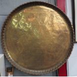 A large brass tray of Eastern design, 65cm diameter