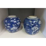 A pair of blue and white Chinese ginger jars (lacking lids), decorated with cherry blossom and