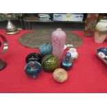 A collection of glass paper weights, iridescent scent bottle and two art glass vases (8)