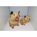 Two colourful resin pig figures, 18cm and 14cm tall