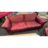 A large four seater leather sofa with stud detail