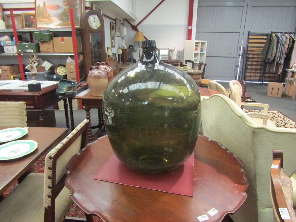 A large oversized green carboy, approx. 60cm tall